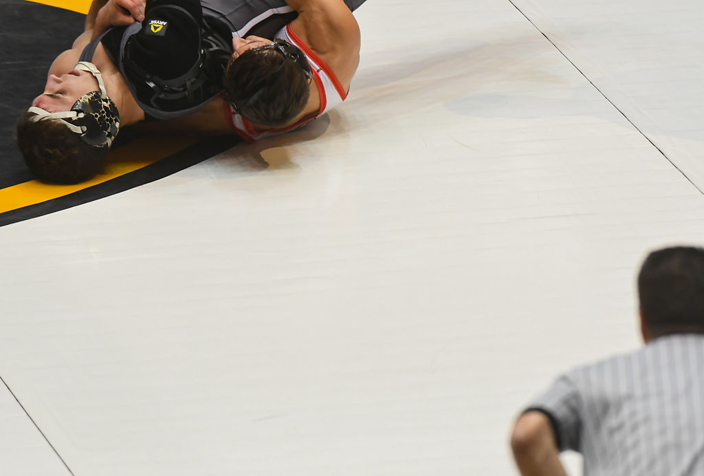 Missouri's Grant Leeth wrestles Northern Illinois' Anthony Gibson while an official watches